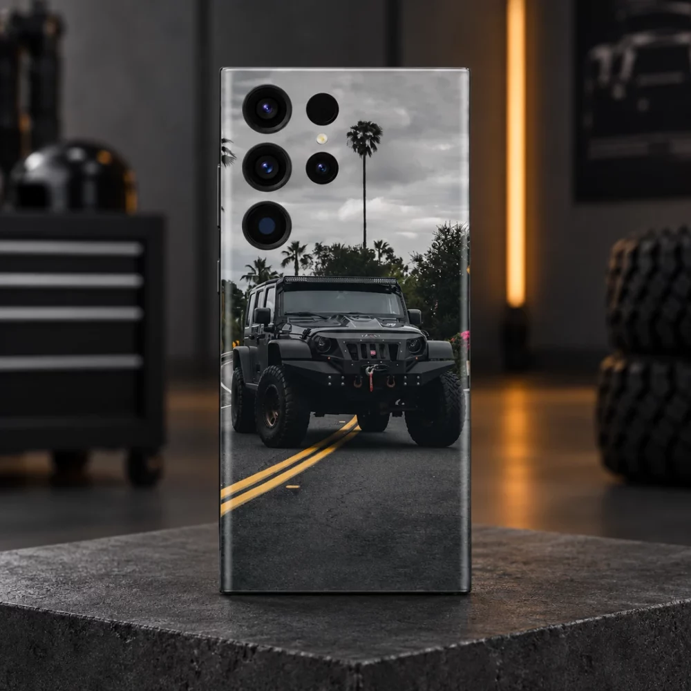 Black off-road SUV mobile skin with palm trees, a cloudy sky and yellow road lines, charcoal garage hero