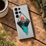Mountain Art Mobile Skin with orange sun and turquoise river, camping table flat lay