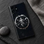 Black Nataraja cosmic mobile skin flat lay on charcoal slate