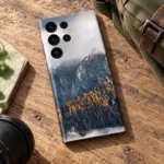 Natural Mountain Autumn Forest Mobile Skin shown diagonally on an oak travel desk