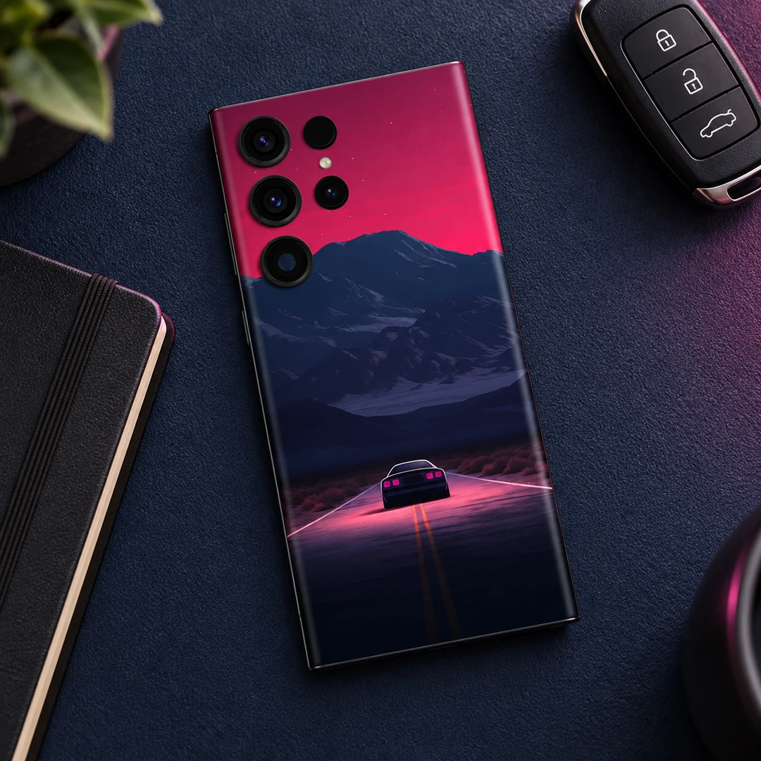 Night Journey Mobile Skin - Navy Desk Flatlay Night Journey mobile skin with a car on a pink-lit road beneath navy mountains, navy desk flatlay