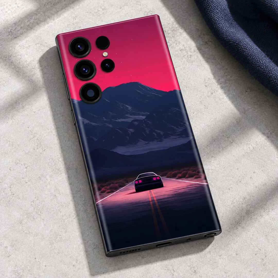 Night Journey Mobile Skin - Stone Detail Night Journey mobile skin with a car on a pink-lit road beneath navy mountains, stone detail