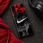 Black phone skin with white swoosh and red and grey smoke, streetwear flat lay
