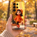 Orange hoodie girl mobile skin with golden autumn artwork, handheld view