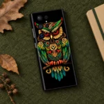 Black mobile skin with ornate green gold and red owl artwork - olive flat lay
