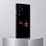 Red Anime Eyes Black Mobile Skin shown at an angle on a brushed silver pedestal