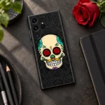 Rose Skull Mobile Skin with red rose eyes and colourful floral details, art desk flat lay