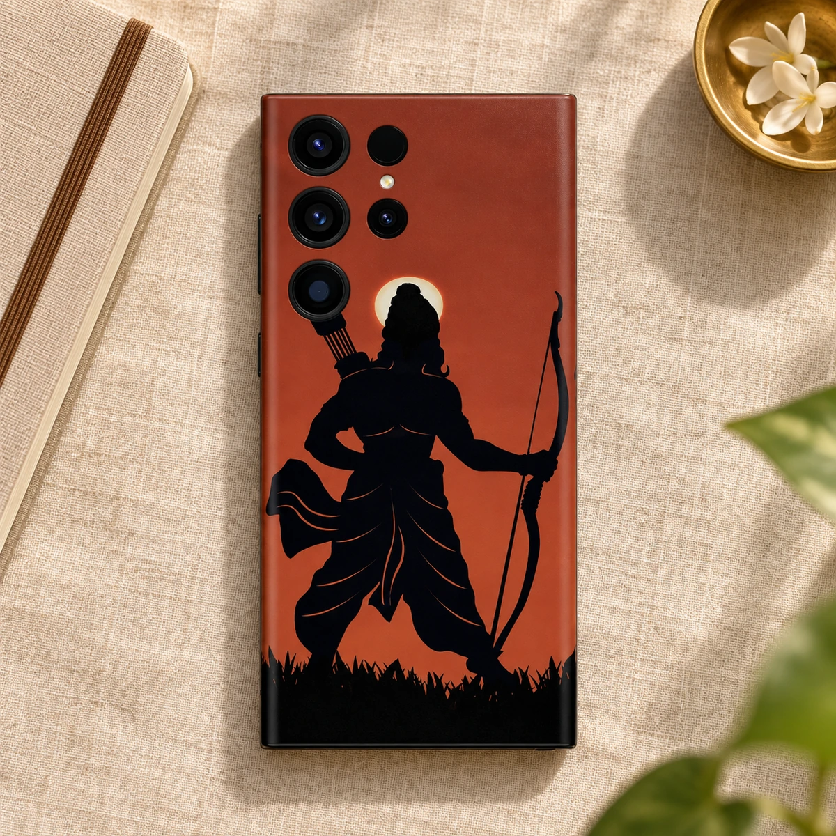 Shree Ram Rust Orange Archer Mobile Skin - Saffron flatlay Rust orange Shree Ram mobile skin on linen beside a notebook and brass dish