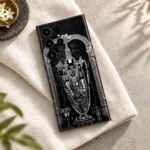 Monochrome Balaji idol mobile skin on ivory linen in a soft daylight flat lay
