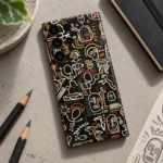 Black Skull Doodle Pattern mobile skin with cream line art, artist desk flat lay