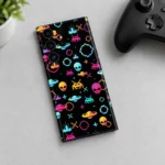 Space Force Mobile Skin with colorful pixel alien and spaceship pattern in a controller desk flat lay photograph