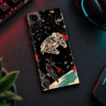 Star Wars mobile skin with Millennium Falcon and TIE fighter artwork on black, gaming desk flat lay