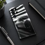 Tesla car mobile skin in black white and silver with light streaks, leather desk view