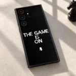 Black The Game Is On mobile skin with white quote and detective silhouette, studio detail