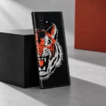 Tiger Face Graphic Mobile Skin shown in a grey and rust studio