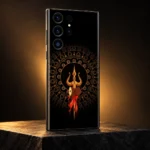 Black and gold Trishul Damru mobile skin in a warm amber studio