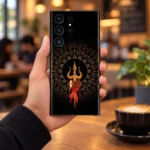 Trishul Damru mobile skin held in hand with a warm cafe background