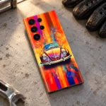 Colorful vintage car mobile skin with orange abstract background, workbench flat lay