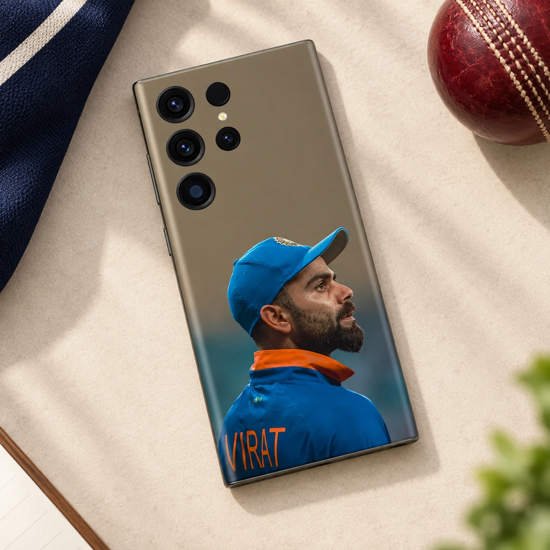 Virat Kohli Blue Cap Portrait Mobile Skin – daylight flat lay Virat Kohli mobile skin with blue cap portrait and VIRAT lettering in daylight flat lay view