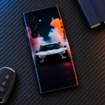White sports car mobile skin with orange purple and cyan smoke artwork, carbon flatlay