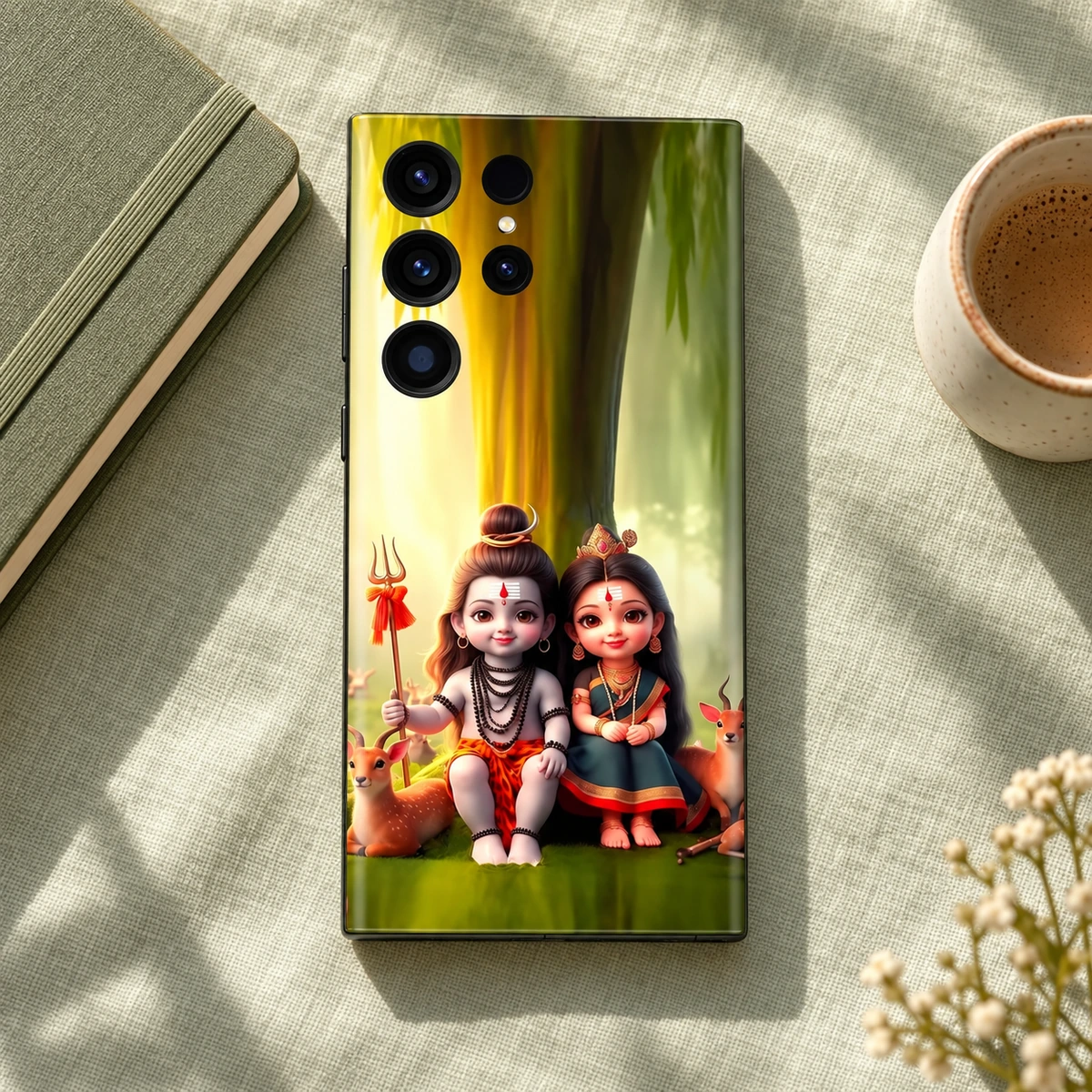 Cute Mahadev Parvati Forest Mobile Skin - Sage flatlay Mahadev with Parvatiji forest mobile skin on sage linen beside a notebook and cup