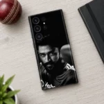Black mobile skin with monochrome MS Dhoni portrait, cricket desk flat lay