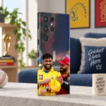 Dhoni and Virat Kohli smiling in yellow and red cricket jerseys on a mobile skin, fan apartment angle