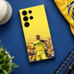 Yellow Dhoni photo mobile skin with wicketkeeping gloves, blue desk flat lay