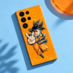 Goku peace sign mobile skin on a golden orange background, blue flat lay