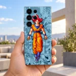 Goku manga mobile skin held outdoors against a bright terrace background