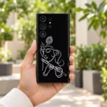 Handheld Krishna white line art mobile skin showing flute and peacock feather in a garden courtyard
