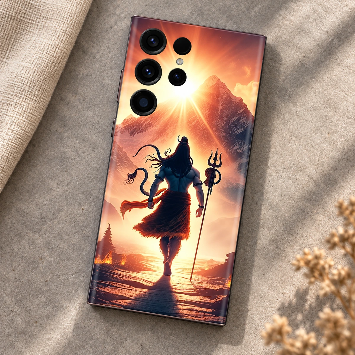 Mahadev Mountain Sunrise Mobile Skin - Stone flat lay Mahadev mobile skin showing Shiva and trishul against a golden mountain sunrise, stone flat lay