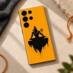 Mahadev saffron meditation mobile skin with black Shiva silhouette and trident – stone flat lay