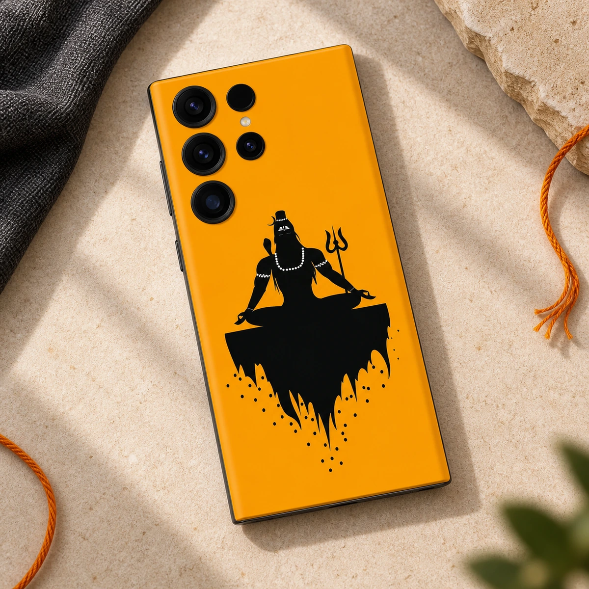 Mahadev Saffron Meditation Mobile Skin – stone flat lay Mahadev saffron meditation mobile skin with black Shiva silhouette and trident – stone flat lay