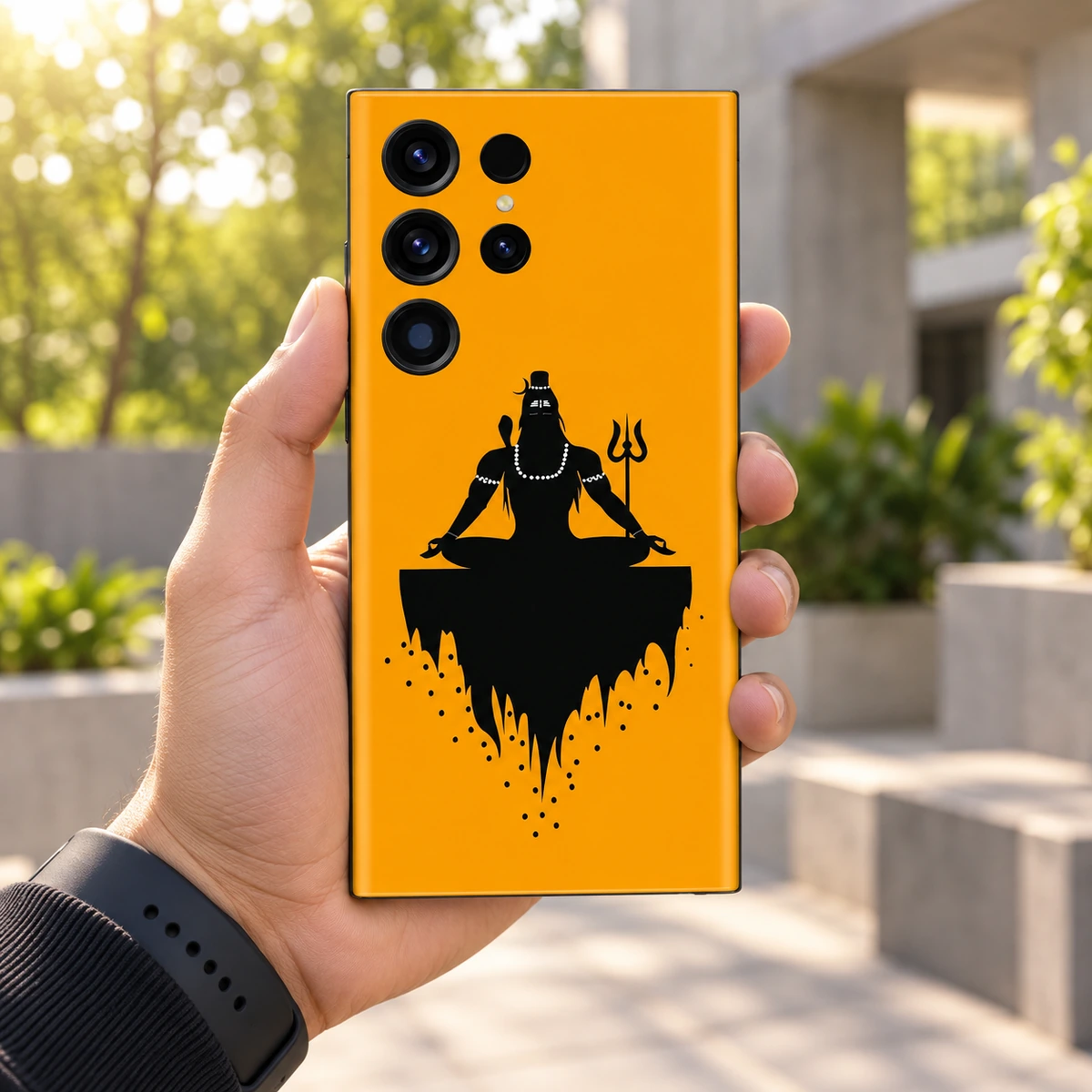 Mahadev Saffron Meditation Mobile Skin – in-hand lifestyle Mahadev saffron meditation mobile skin with black Shiva silhouette and trident – in-hand lifestyle