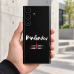Mahadev white script mobile skin held in hand against modern concrete architecture