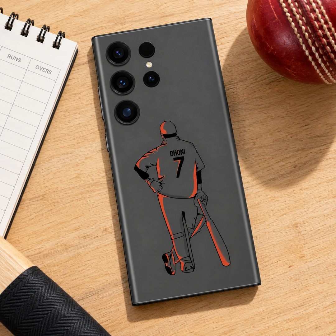 MS Dhoni 7 Grey and Orange Mobile Skin - Wood Desk Flat Lay Grey mobile skin with orange MS Dhoni illustration and DHONI 7 lettering, wood desk flat lay