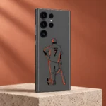 Grey mobile skin with orange MS Dhoni illustration and DHONI 7 lettering, terracotta studio angle