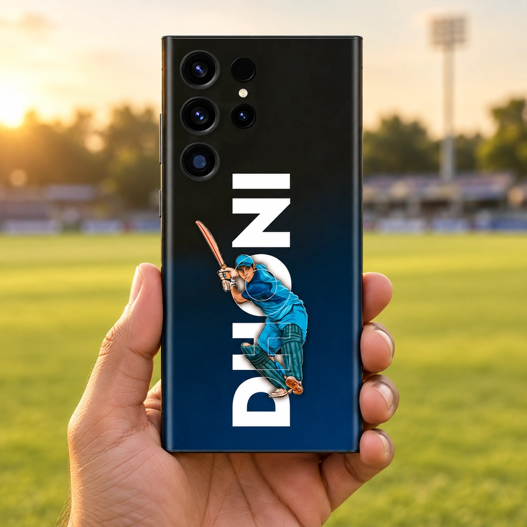 MS Dhoni Batting Mobile Skin – Handheld ground view MS Dhoni mobile skin with blue batting illustration and vertical DHONI lettering, handheld ground view