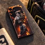 MS Dhoni orange and black helmet montage mobile skin, kit bench view