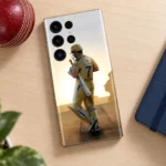 MS Dhoni photo mobile skin with yellow number 7 jersey, cricket desk flat lay