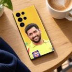MS Dhoni photo mobile skin with smiling portrait and yellow jersey, cafe table view