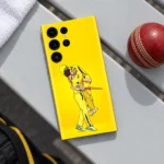 Yellow MS Dhoni celebration mobile skin showing two cricket players embracing, cricket bench flat lay