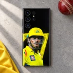 MS Dhoni phone skin with yellow helmet portrait and number 7 on black, cricket desk flat lay