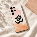 Pastel Om Mahadev mobile skin on ivory linen beside a peach stone tile
