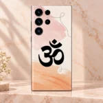 Close view of black Om symbol pink brushstrokes and peach watercolour on mobile skin