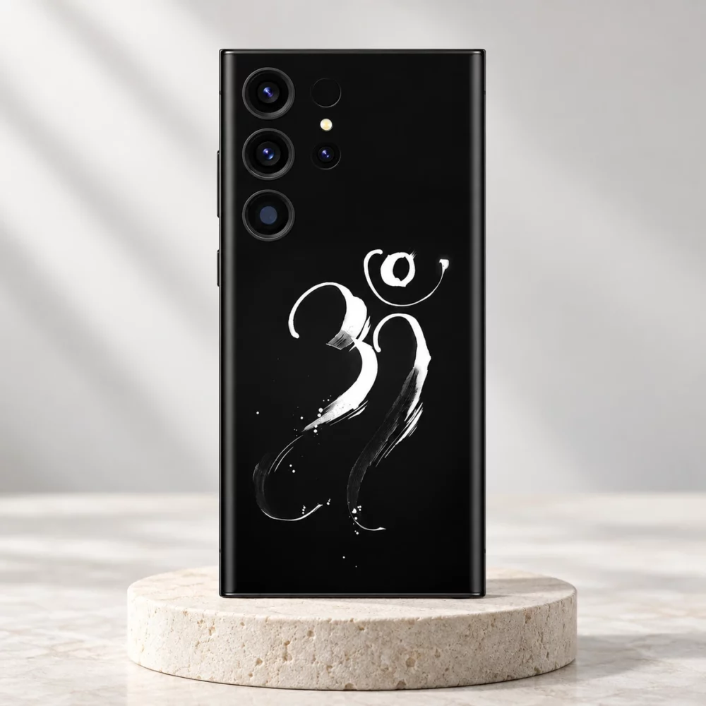 Om Mahadev mobile skin with white brush calligraphy on black displayed on an ivory pedestal