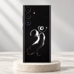 Om Mahadev mobile skin with white brush calligraphy on black displayed on an ivory pedestal