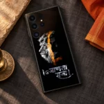 Shivaji Maharaj and lion portrait mobile skin in a charcoal linen flatlay with saffron accents