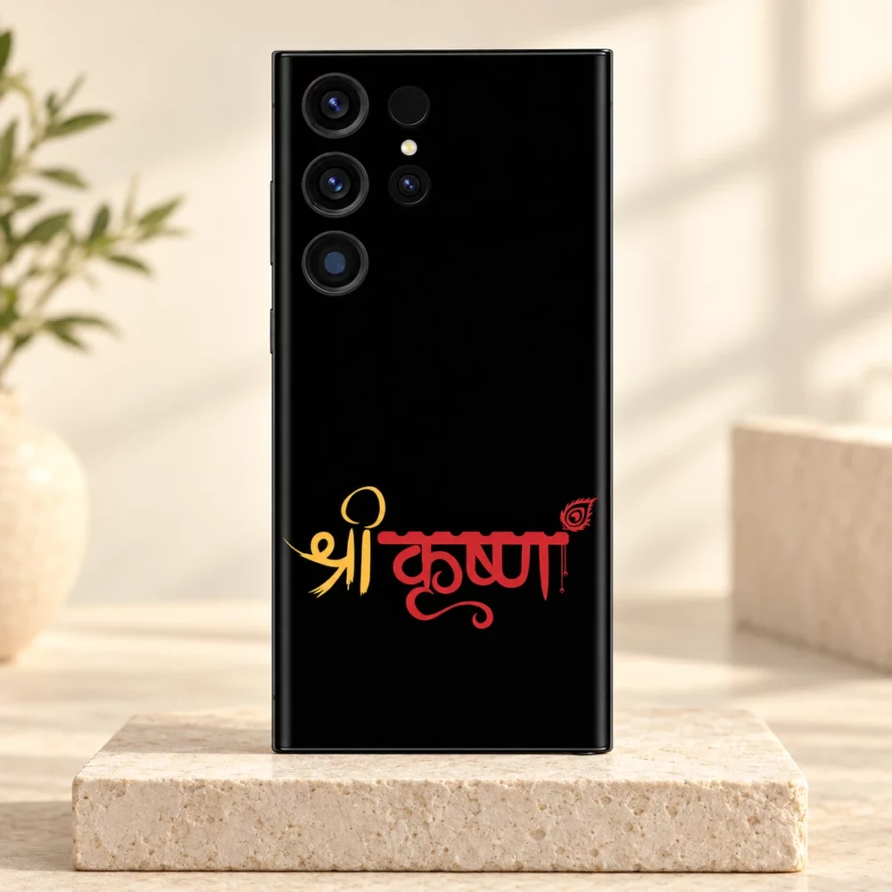 Shree Krishna red and gold script mobile skin upright on a light stone plinth